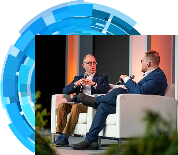 Two men on stage having conversation
