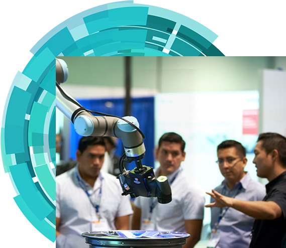 An exhibitor introducing a robot to three show attendees